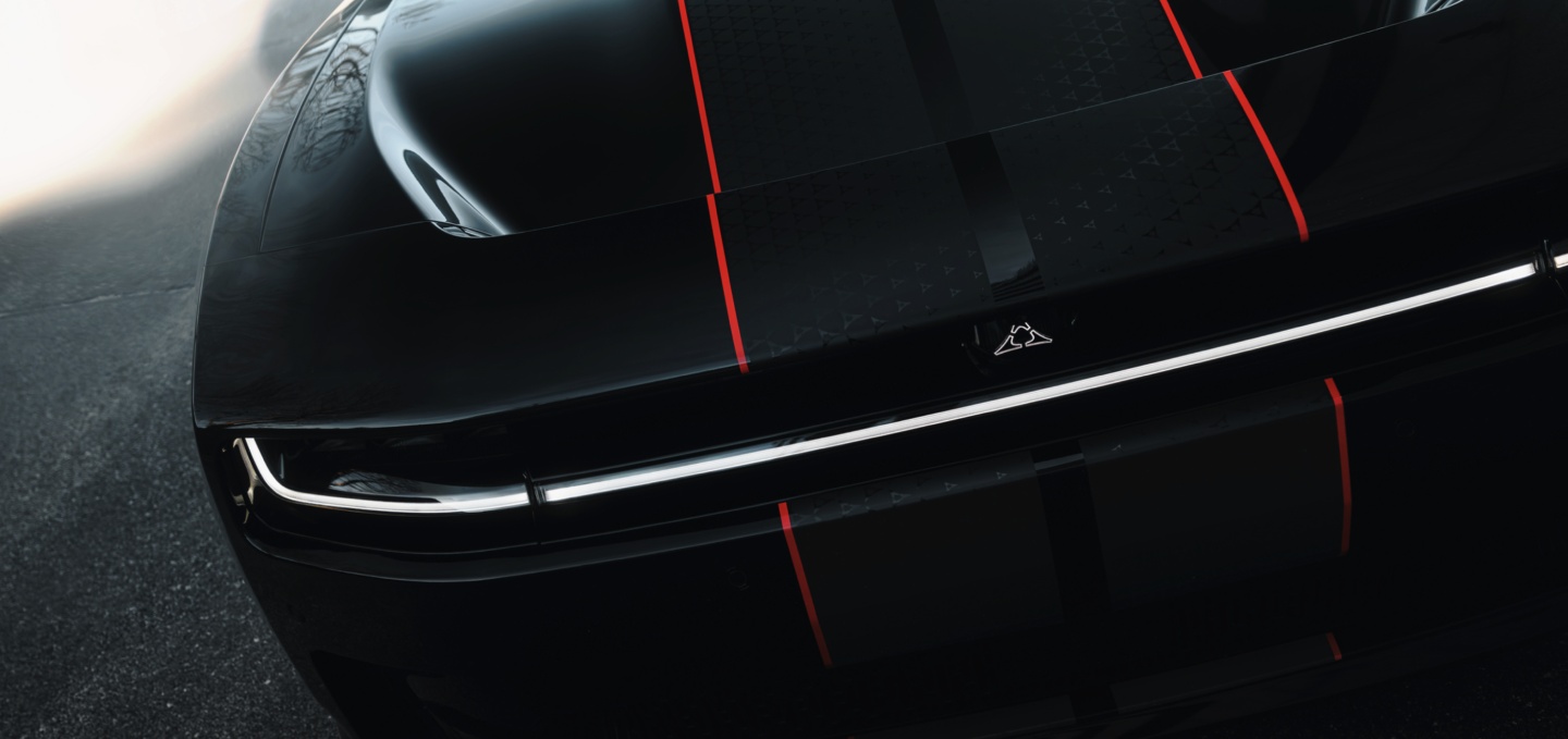 The hood and front end of a black  2027 Dodge Charger Scat Pack with dual black and red center stripes.