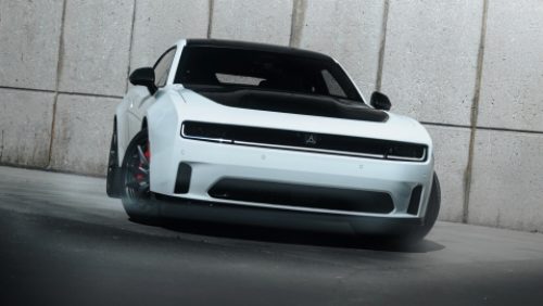 A white 2027 Dodge Charger Daytona Scat Pack with a black hood insert.
