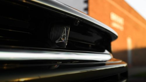 The rear spoiler on a white 2027 Dodge Charger Scat Pack.